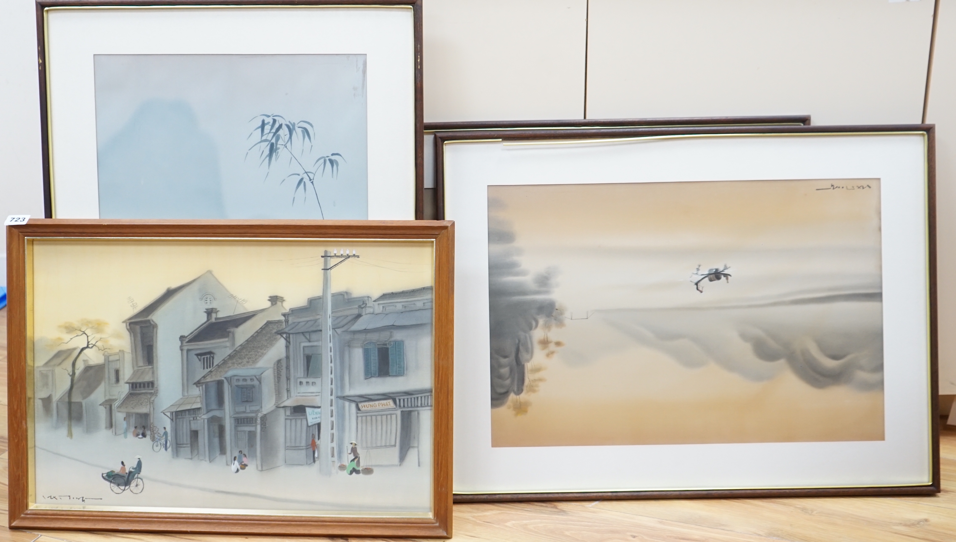 Four 20th century Vietnamese watercolour paintings on silk depicting street scene, lake scene and rice planting, all signed, largest 56 x 36cm, glazed frames
